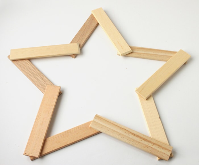 Make this pretty wooden star DIY Christmas decoration for your holiday mantle! It's so easy to make and looks so pretty when it's done!