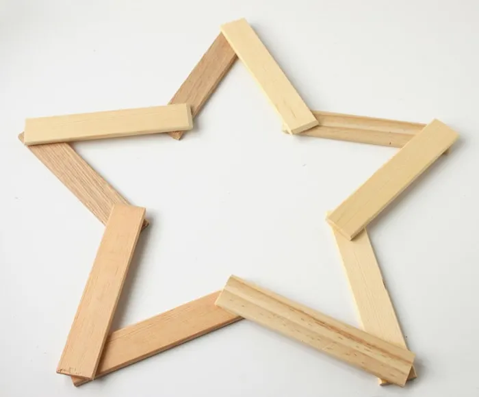 Make this pretty wooden star DIY Christmas decoration for your holiday mantle! It's so easy to make and looks so pretty when it's done!