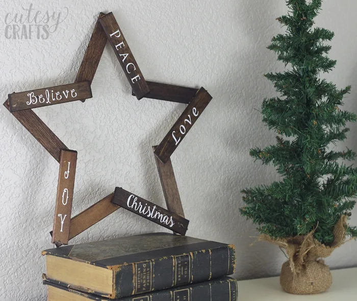 Make this pretty wooden star DIY Christmas decoration for your holiday mantle! It's so easy to make and looks so pretty when it's done!