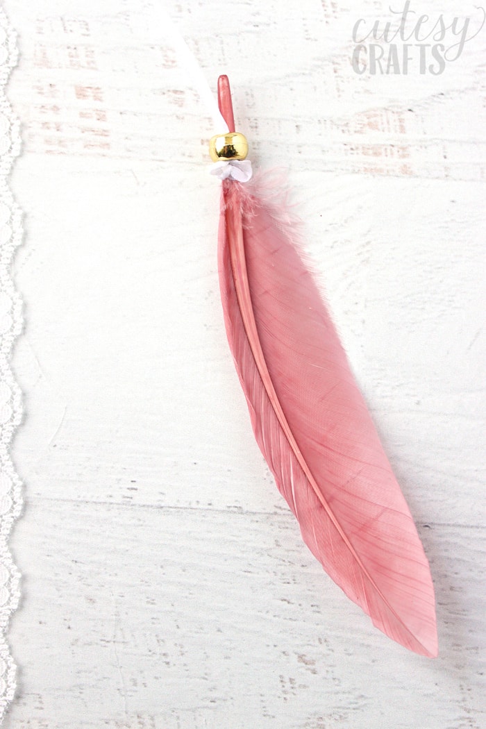pink feather on a ribbon