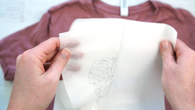 Use water soluble stabilizer to transfer an embroidery design onto a t-shirt.