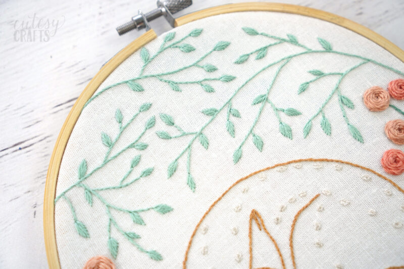 Embroider small leaves.
