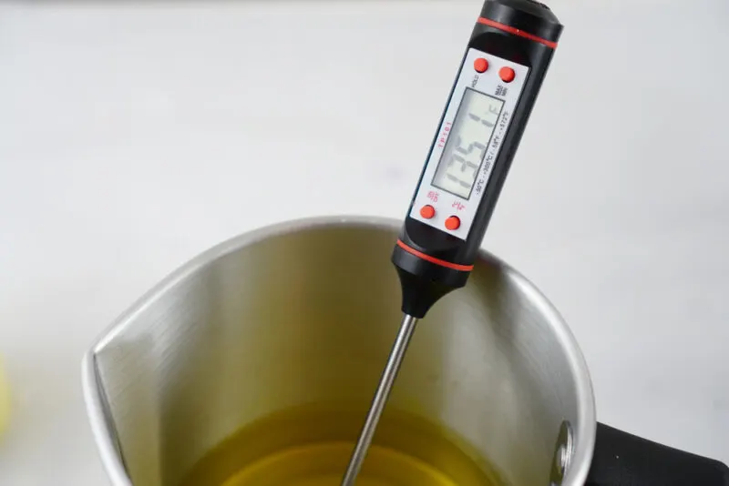 Premium Photo  Homemade candle making session using soy wax and assorted  glass containers photo shows a pair of hands using a thermometer to check  the temperature of soy wax